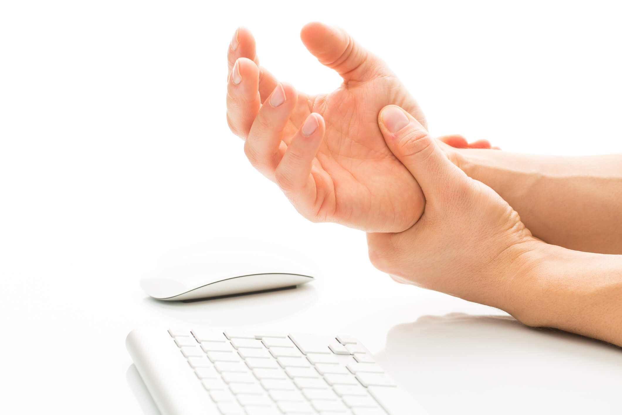 Closeup of an Orthopaedic Hand and Arm Center patient holding their wrist in discomfort.